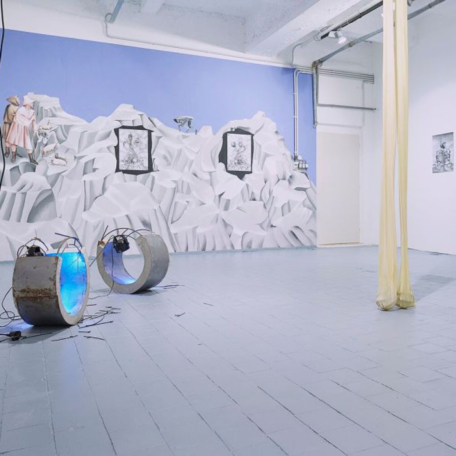 Installation view of the exhibition, ‘ Extra - Planetary Commitment’ , lítost gallery, Prague, 16 March 2019 – 28 April 2019 . From left to right: Evita Vasiljeva, ‘Hormones’ , (2017), metal, concrete, wood, cable ties, noise sensitive light, wires, each part 25 cm x 57 cm x 57 cm – Courtesy of the artist gallery; Botond Keresztesi, “Miss Universe 1” , black colour airbrush on paper, 29.7 cm x 42 cm – Courtesy of the artist; Botond Keresztesi, “Miss Universe 2” , black colour airbrush on paper, 29.7 cm x 42 cm – Courtesy of the artist ; Evita Vasiljeva – ‘There is no Grace in Shrinking’ , (2017), latex, pump, plastic tubes, various sizes – Courtesy of the artist; And Botond Keresztesi, “The Audience” , black colour airbrush on paper, 29.7 cm x 42 cm – Courtesy of the artist . Photograph by Lenka Glisníková. © lítost