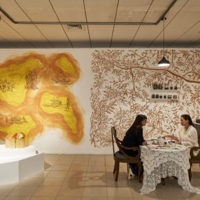 Installation view – Right: Yasmin Jahan Nupur, ‘Let Me Get You a Nice Cup of Tea’, 2019–20, antique furniture, antique tea set, embroidered textiles, tea, performance. Commissioned for DAS 2020. Courtesy of the artist and Exhibit320, with support from the Peabody Essex Museum, Salem. Left: Elia Nurvista, ‘Sugar Zucker’, 2016-2020, crystallised sugar, mural. Courtesy of the artist.
